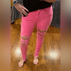 Vibrant pink‎ distressed stretch jeans